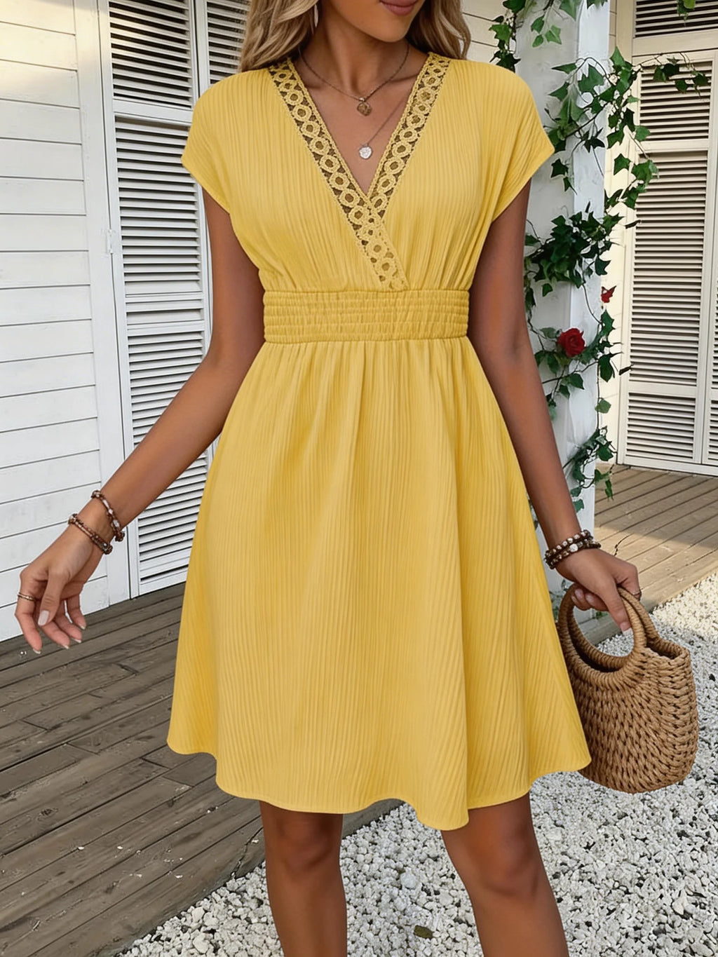 French lace V-neck fitted dress with waistline and short puff sleeves. Striped texture short skirt with vertical lines. Beach-st