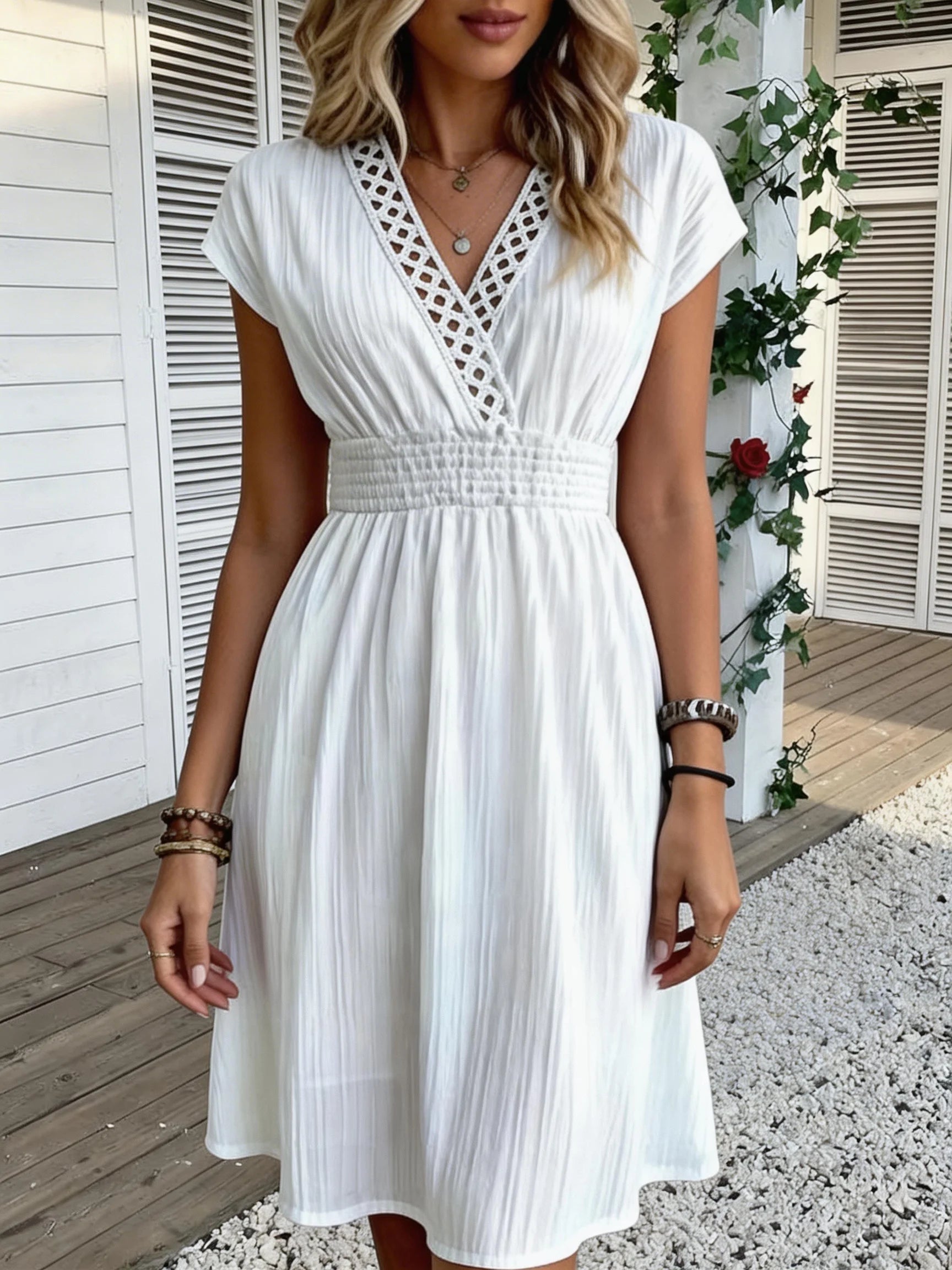 French lace V-neck fitted dress with waistline and short puff sleeves. Striped texture short skirt with vertical lines. Beach-st